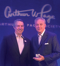 Roger Bolton, president of the Arthur W. Page Society, congratulates Looser.